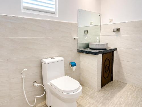 a bathroom with a toilet and a sink at Bundala Forest Resort Yala in Weerawila
