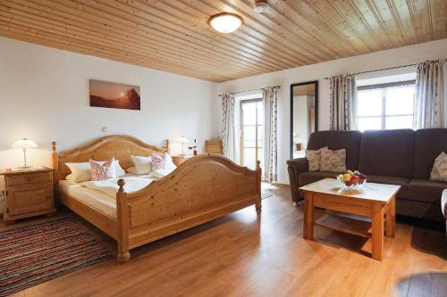 a living room with a bed and a couch at Mojer-Hof in Taching am See