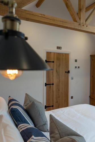 a black lamp hanging over a bed in a room at The Chequers at Burcot in Oxford