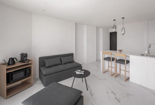 a living room with a couch and a table at Plott The Gak Yangyang in Yangyang