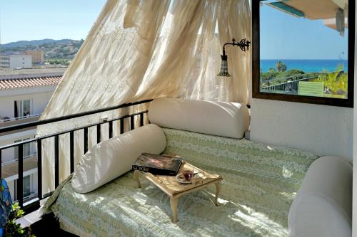 a balcony with a couch and a table at Seaview Beach Residence Malgrat de Mar in Malgrat de Mar