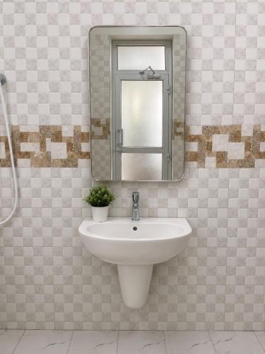 a bathroom with a sink and a mirror at Jules Place Arusha in Themi