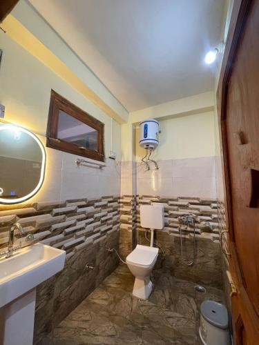 a bathroom with a toilet and a sink at Infinity Snowline , Kalga in Kalgha