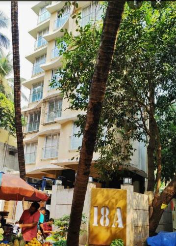 a hotel with a sign in front of a building at ConnektHomes - Modern2Bed-BandraArea in Mumbai