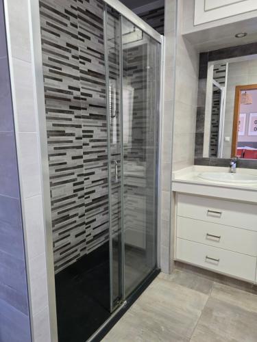 a glass shower in a bathroom with a sink at Pool&River Villa in Alcoutim