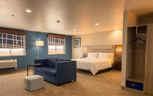 a bedroom with a bed and a couch and a chair at Holiday Inn Express Pendleton by IHG in Pendleton