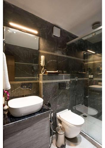 a bathroom with a sink and a toilet and a shower at Hotel Raaj Palace in Agra