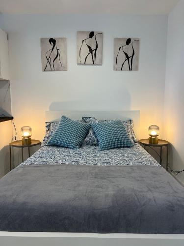 a bedroom with a bed with three pictures on the wall at Marta in Carini
