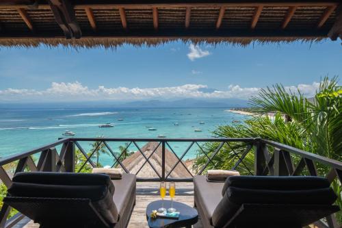 a view of the ocean from the balcony of a resort at Villa Atas Lembongan in Nusa Lembongan