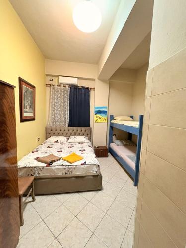 a bedroom with a bed and two bunk beds at Hotel-Bar-Riviera in Lezhë