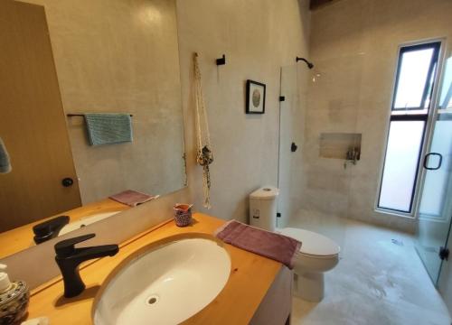 a bathroom with a sink and a toilet at Casa Colibri San Cristobal in San Cristóbal de Las Casas