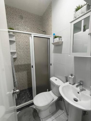 a bathroom with a shower and a toilet and a sink at Cantinho de Mindelo in Mindelo