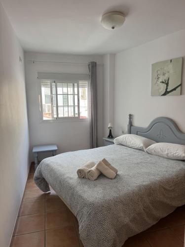 a bedroom with a bed with a towel on it at Turquesa Zon & Strand Carihuela in Torremolinos