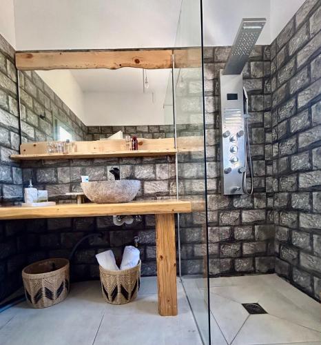 a bathroom with a counter and a stone wall at Theochloe Patmos House in Patmos