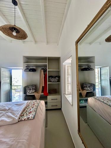 a bedroom with a bed and a mirror at Theochloe Patmos House in Patmos