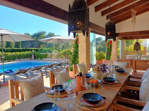 a dining room with a table and a pool at Villa Villa Lantana by Interhome in Jávea