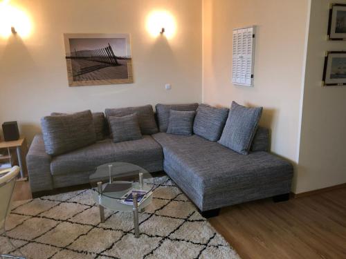 a living room with a couch and a table at Hafenidyll mit Wasserblick in Karlshagen