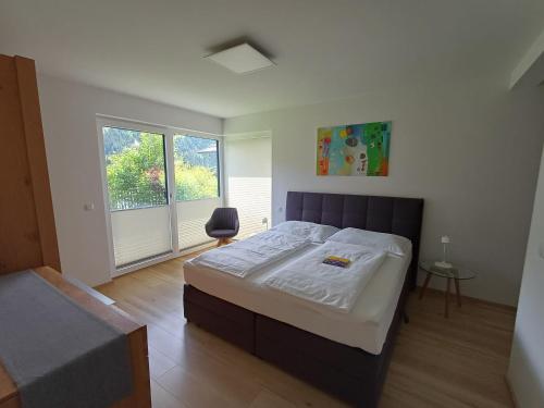 a bedroom with a large bed and a window at Ferienhaus Lurger in Strassen