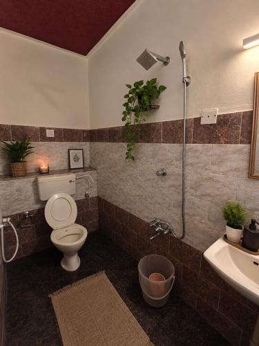 a bathroom with a toilet and a sink and a shower at The cliff boutique in Varkala