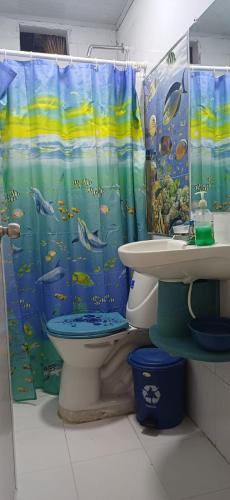 a bathroom with a toilet and a shower curtain at Casa SAYBER DON DIEGO in Don Diego