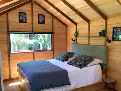 a bedroom with a bed in a room with a window at La Crampotte de Bidart, proche Océan in Bidart