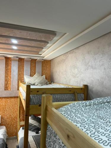 a room with two bunk beds in it at Abrid Surf in Tamraght Ouzdar