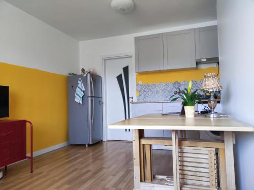 a kitchen with a table and a refrigerator at Lovely Studio with a Balcony in Sinemorets