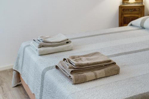 two beds with towels sitting on top of them at Bed and Breakfast Al Vecio Morer in San Donà di Piave