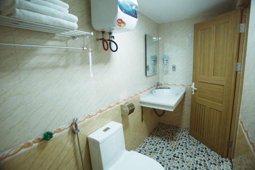 a small bathroom with a toilet and a sink at Tân Trang in Ha Long