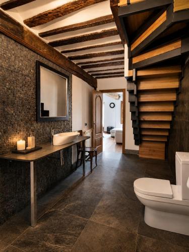 a bathroom with a sink and a toilet at El Palacito de Villoslada in Villoslada de Cameros