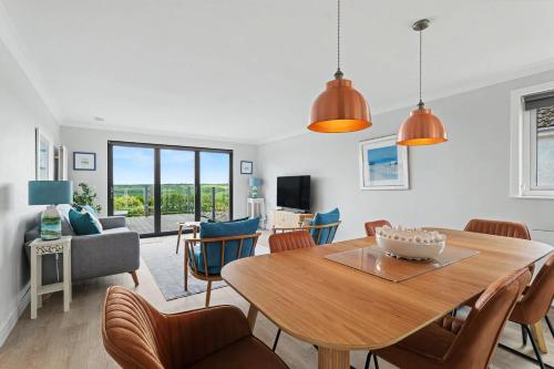 a living room with a dining room table and chairs at Stylish 3 Bedroom with Balcony and Amazing View in Dollar