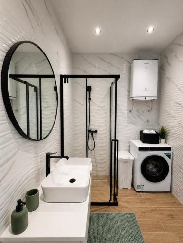 a bathroom with a sink and a washing machine at Apartment Lidija in Split