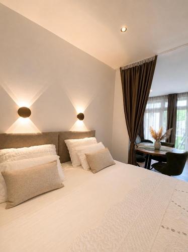 a bedroom with a large white bed and a desk at Apartment Lidija in Split