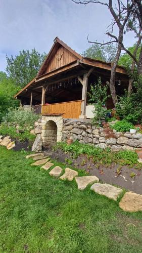 a stone house with a stone path in front of it at Hidden Garden Kide (Chidea) in Cluj-Napoca