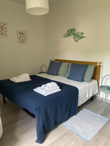 a bedroom with a bed with towels on it at Appartamento La Fontina in Marciana Marina