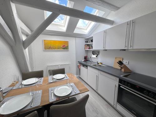 a kitchen with a dining table and a skylight at Brauhaus Suite 16 in Sebnitz