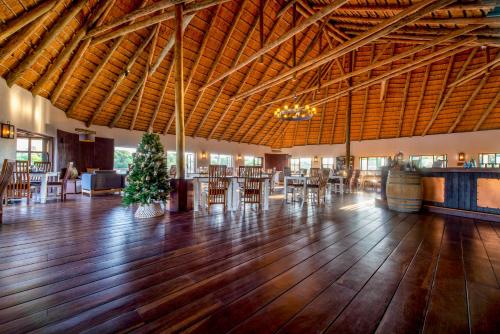 a lobby with a christmas tree in the middle of a room at Gondwana Hakusembe River Lodge in Rundu