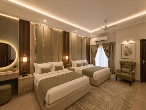 a hotel room with two beds and a chair at Prime Stay Bosan Hotel Multan in Multan