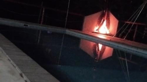 a reflection of a fire in a window at night at Marloth Park, Kruger safari house - solar in Marloth Park