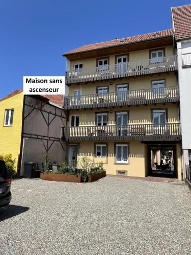 a building with a balcony on the side of it at Appartements centre ville Colmar 4 familles in Colmar