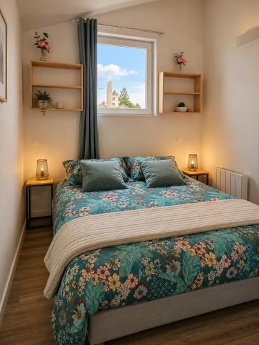 a bedroom with a large bed with a window at Le Studio, proche du puy in Saint-Pierre-Montlimart