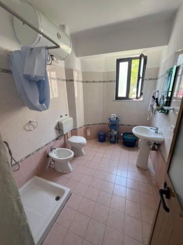a bathroom with two toilets and a sink at Vila Vollga in Durrës