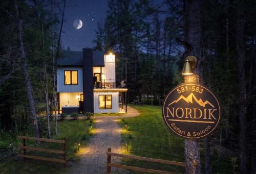 a sign in front of a house at night at Condo and Spa - Le Saloon Nordik in Saint Come