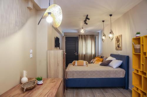 a small bedroom with a bed and a table at Cozy Twins - Terra in Kavála
