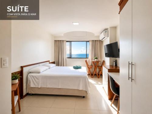a hotel room with a bed and a television at Flat Pasárgada 404 in Vila Velha