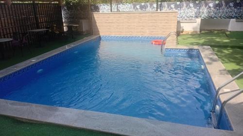 a large blue swimming pool in a yard at D'Mayor Suites, Gwarinpa in Gwarinpa