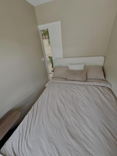 a bed in a small room with a window at Nordic Retreat Quiet Oasis in Oslo in Oslo