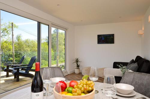 a living room with a table with a bowl of fruit at Kilbride Lodge in Carrick