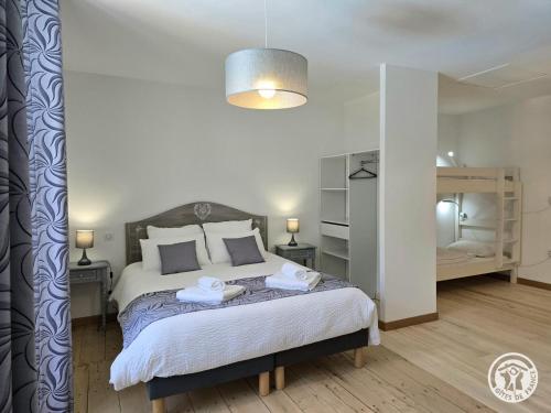 a bedroom with a bed with two towels on it at Chadalou in Savignac-les-Églises