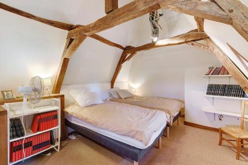 a bedroom with a bed and a book shelf at Maison Des Hôtes - Dordogne in Saint-Crépin-dʼAuberoche